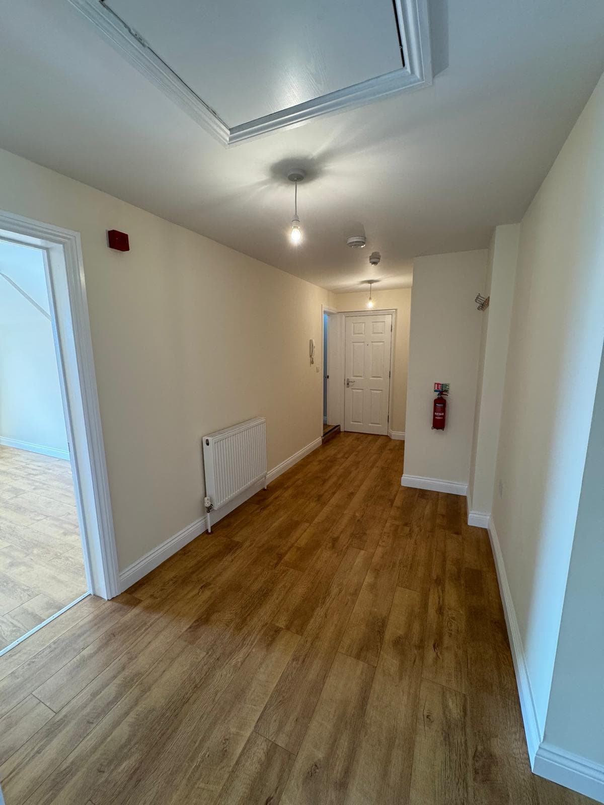 Flat renovation hallway with cream walls and oak flooring